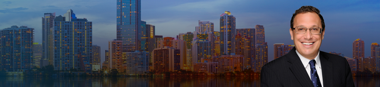 Attorney David H. Pollack in front of a city skyline at sunset